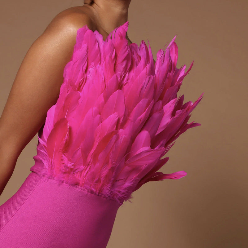 Mannequin displaying a hot pink strapless bodycon dress with feather embellishment