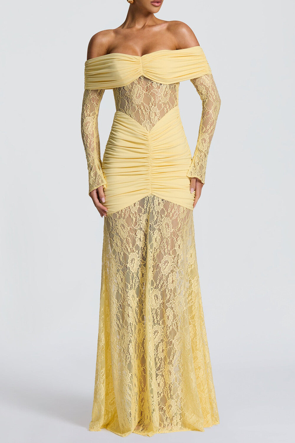 A pale yellow off-the-shoulder formal dress with long lace sleeves and ruched detailing, shown from the front on a white background.