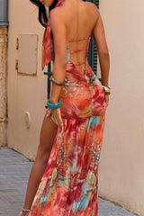 Rear view of a woman in a strapless maxi dress with a criss-cross back and a high slit.
