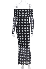 A black and white polka dot off-the-shoulder maxi dress with long sleeves displayed on a mannequin against a white background.
