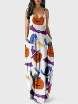 Woman wearing a white maxi dress with a Halloween print featuring pumpkins, bats, and zombies.