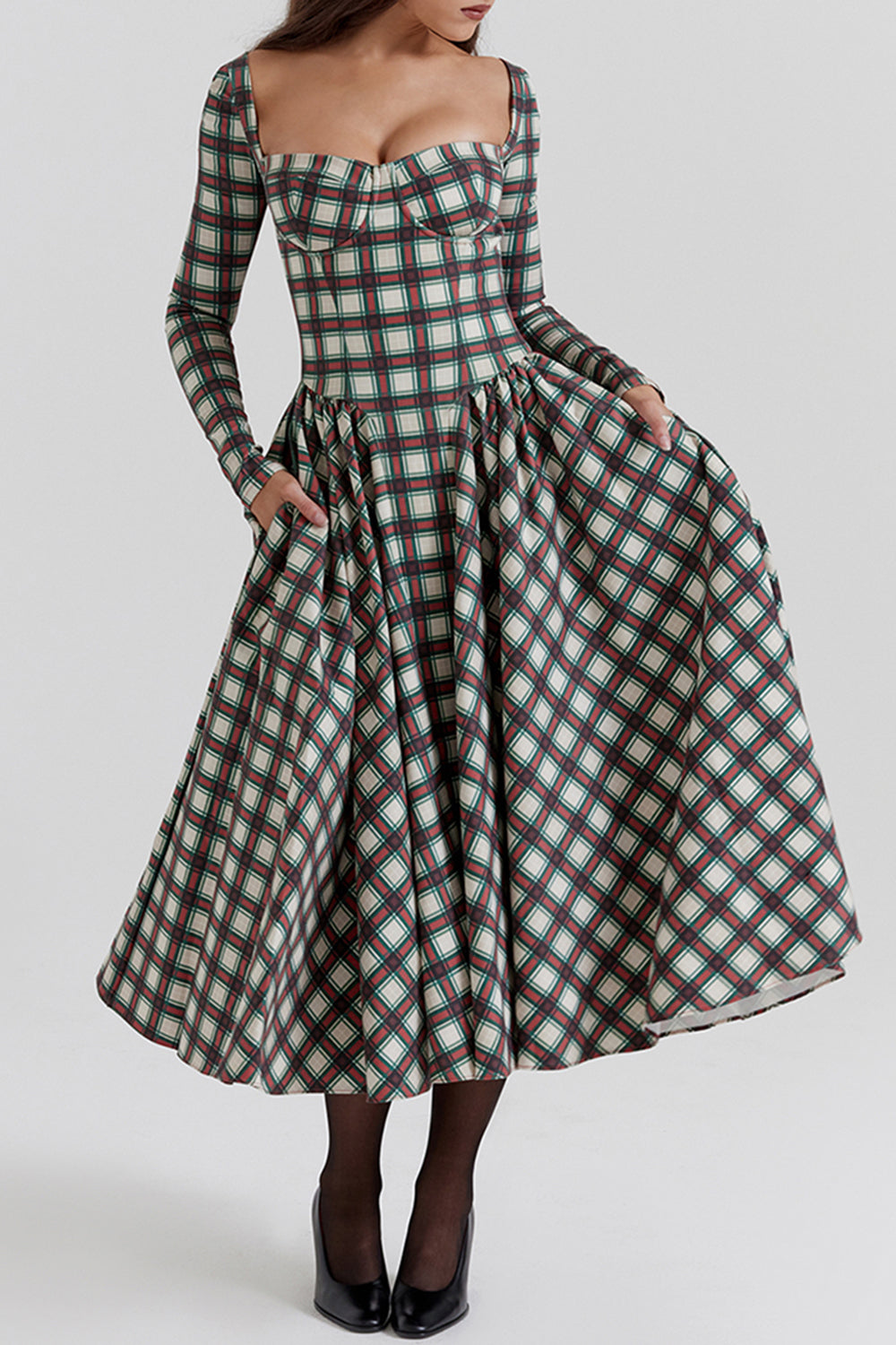 Woman in a plaid midi dress with pockets, showing the full skirt.