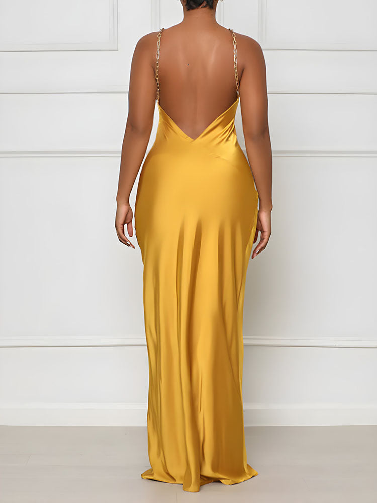 back view of a woman in a yellow satin halter dress with a deep V-back