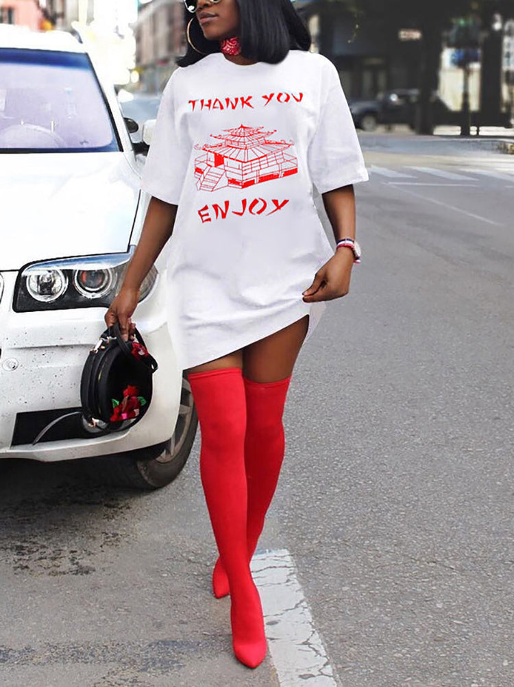 Woman wearing a white t-shirt dress with red graphic print and red thigh-high boots