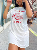 Close-up of a woman wearing a white t-shirt dress with red graphic print