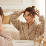 A woman using the claw clip to style her hair in a bun