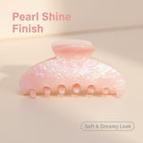 Pink pearlescent claw clip with text 'Pearl Shine Finish' and 'Soft & Dreamy Look'