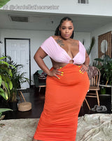 woman wearing a pink and orange color block ruched dress
