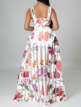 Rear view of a woman wearing a white floral and striped maxi dress.