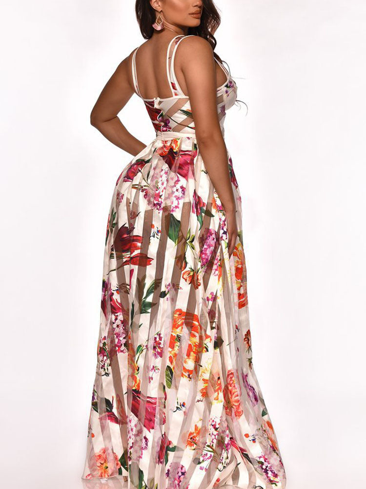 Back view of a woman wearing a white floral and striped maxi dress.