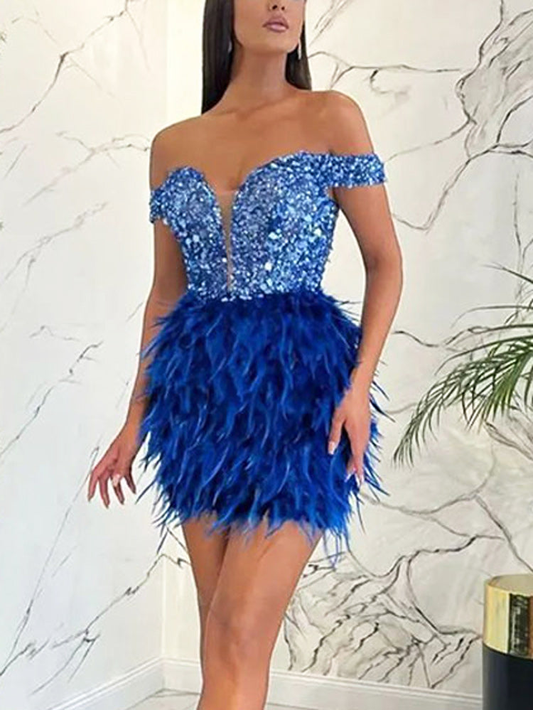 Woman posing in a royal blue sequined and feathered mini dress.