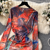 Back view of the long-sleeved abstract print maxi dress, highlighting the full coverage and pattern.
