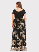 Back view of a plus-size model in a long black dress adorned with gold sequined floral patterns