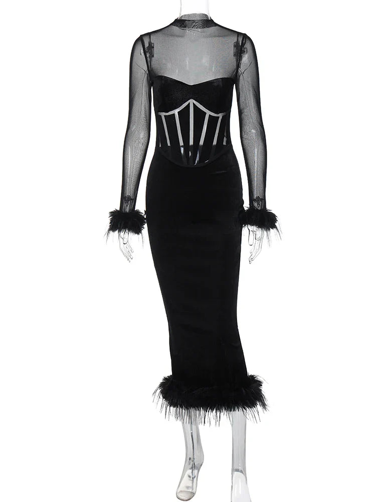 Black velvet midi dress with sheer sleeves and feather trim on a mannequin