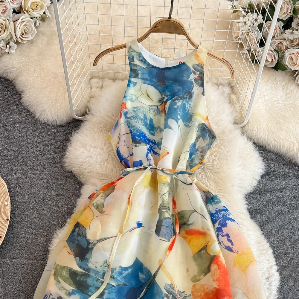 Close-up of the bodice and tie waist of a sleeveless abstract floral print maxi dress.