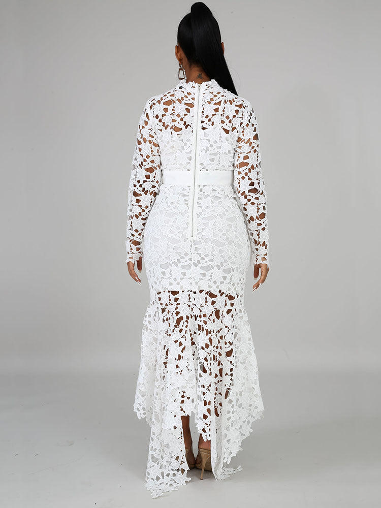Rear view of a woman in a white lace maxi dress with a high neckline and long sleeves, showcasing the zipper closure.