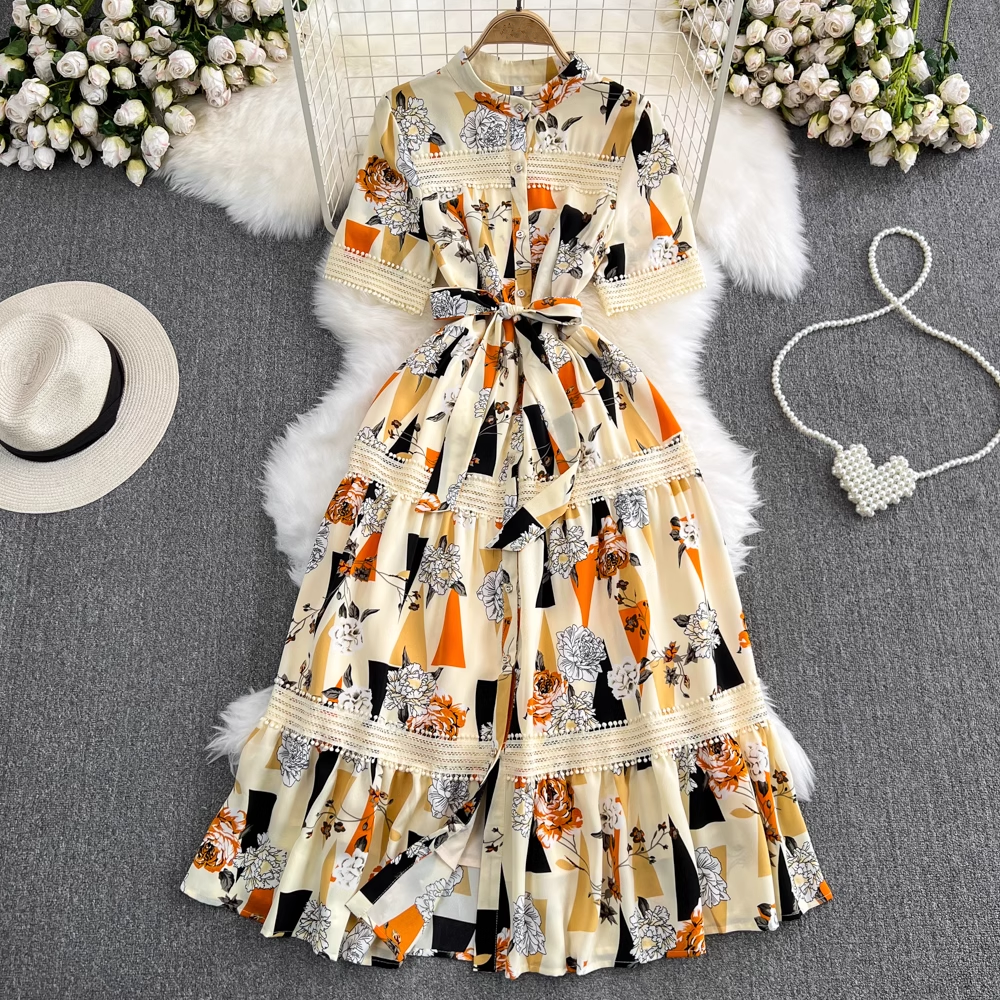 A floral and geometric print maxi dress laid flat on a faux fur rug.