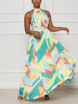 woman twirling in a pleated geometric print maxi dress
