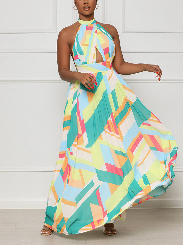 woman twirling in a pleated geometric print maxi dress