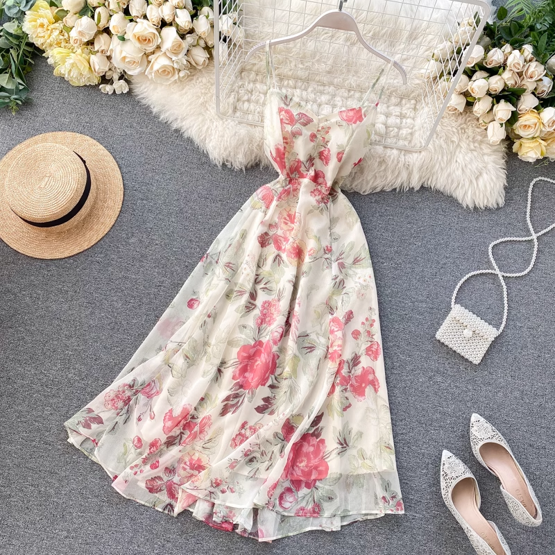 A close-up of the floral print on the sheer chiffon dress, showing pink and red flowers with green leaves.