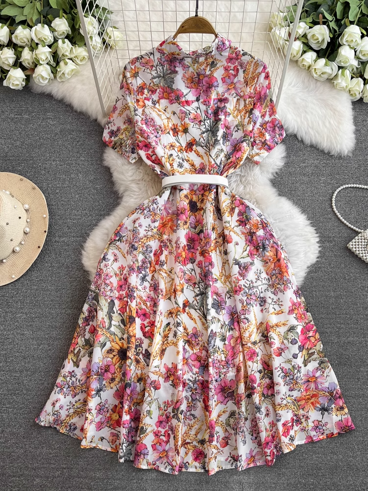 Close-up of the floral print on a white midi dress with a button-down front.