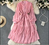 Pink chiffon tiered midi dress with puffed sleeves and self-tie belt