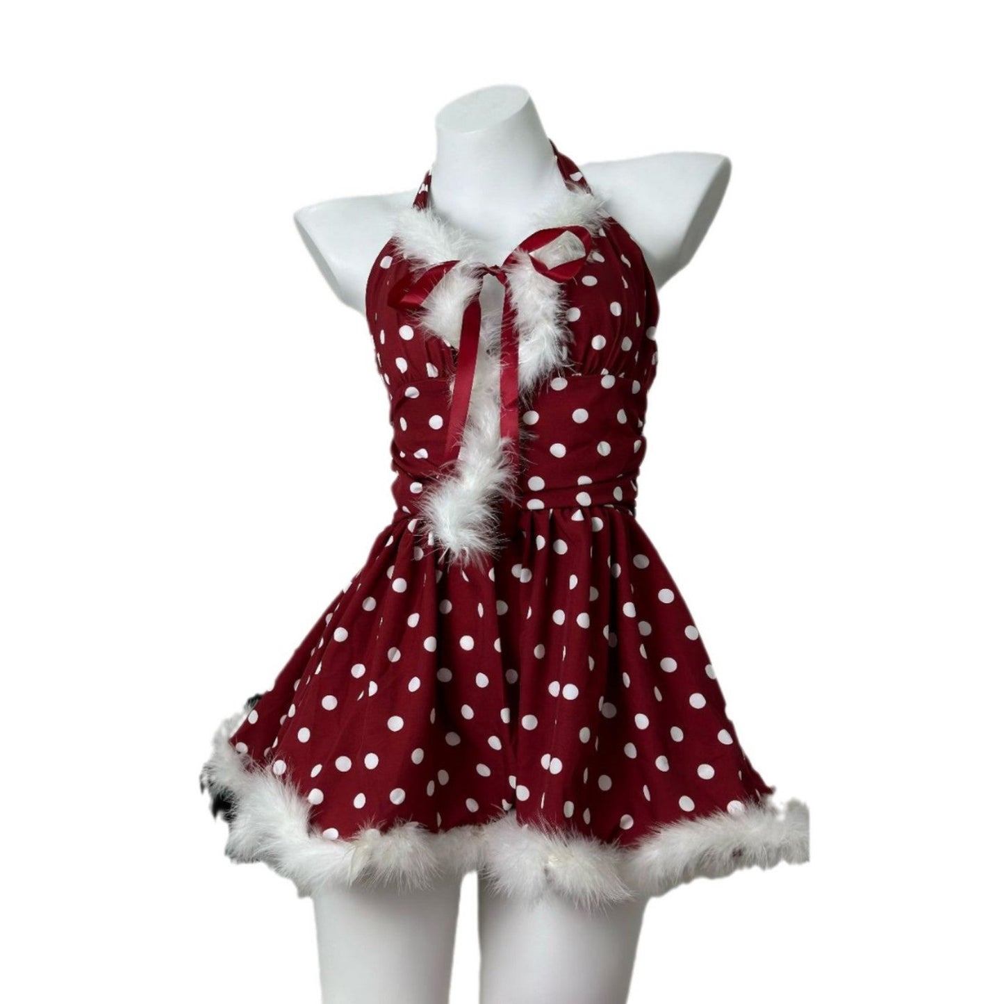 studio shot of a red and white polka dot halter dress with faux fur trim on a mannequin