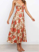 Full-body view of a woman in a floral print midi dress with cut-out detail.