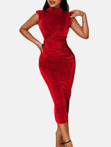 Woman wearing a red velvet ruched bodycon dress with a high neck and sleeveless design.