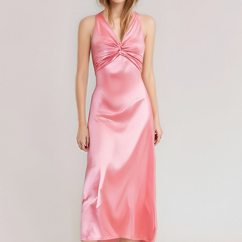 Pink satin maxi dress with a twisted halter neckline and flowing skirt