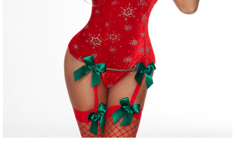 Close-up of the lower portion of a red Christmas corset with green bows and garter straps
