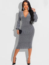 Woman wearing a silver metallic knit V-neck long sleeve bodycon midi dress