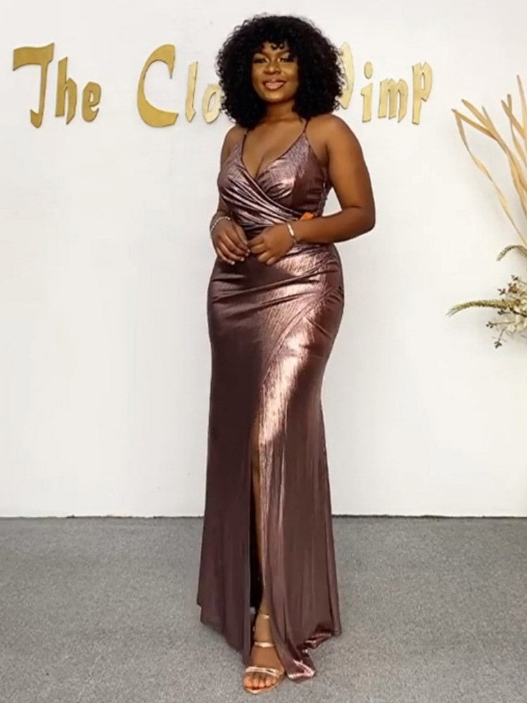 Front view of a woman wearing a long, shimmering dress with spaghetti straps.