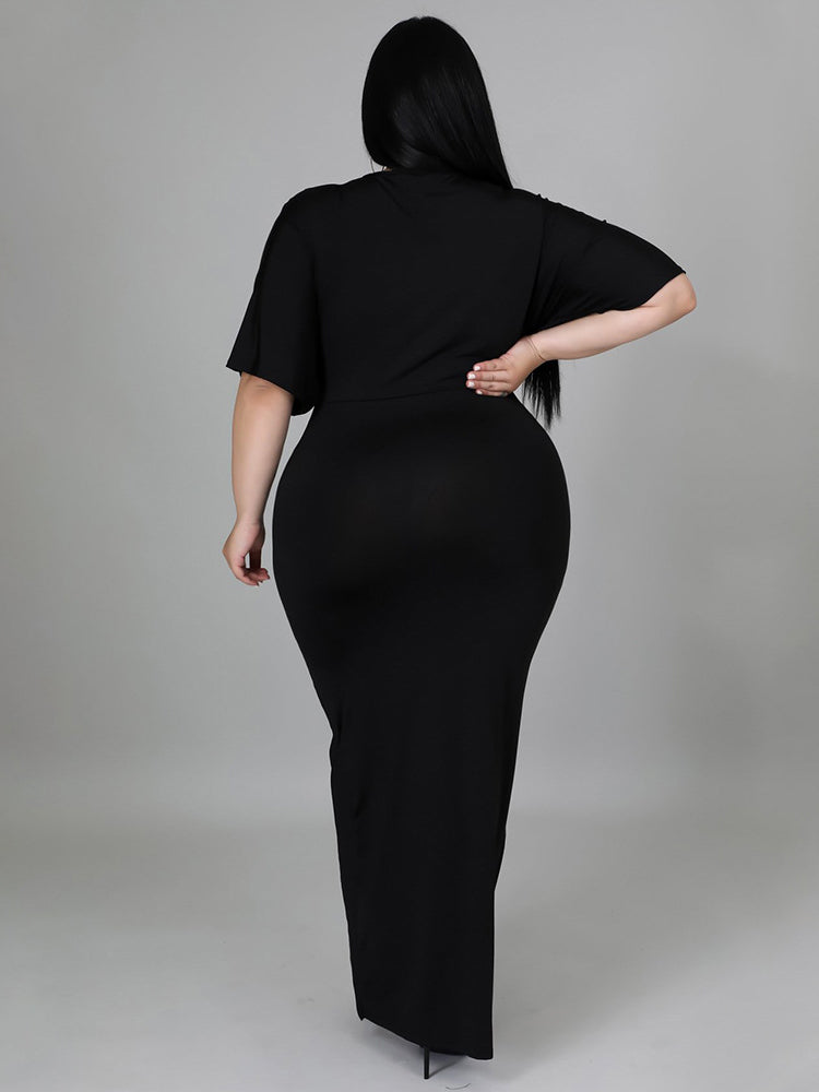 Rear view of a woman wearing a black V-neck maxi dress