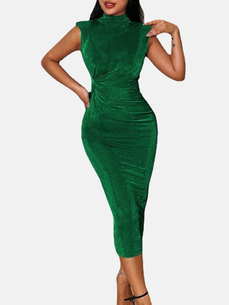 Woman wearing a green velvet ruched bodycon dress with a high neck and sleeveless design.