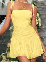 detail of the ruched section of a yellow chiffon dress