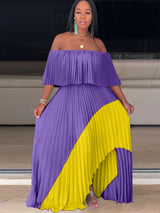 Woman wearing a purple and yellow off-the-shoulder pleated maxi dress with an asymmetrical hem.