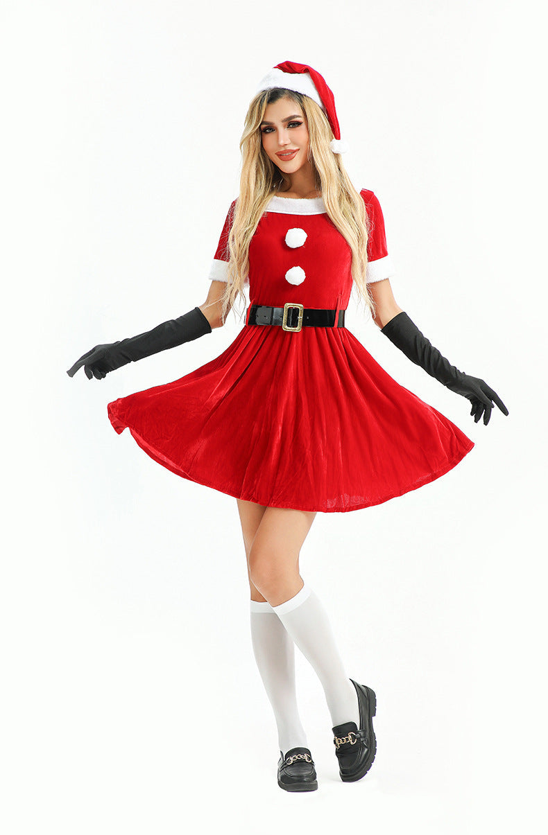 Woman modeling a short red velvet dress with white pom-poms and a matching Santa hat.