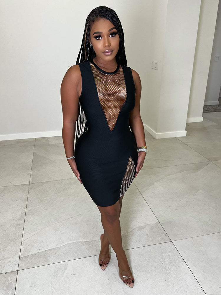 Woman wearing a black sleeveless bodycon mini dress with a plunging V-neckline featuring a mesh inset with embellishments and a side slit with embellishments.