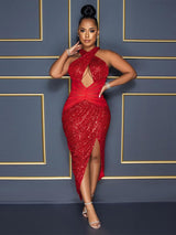 Woman wearing a red sequined halter dress with a plunging neckline and high slit.