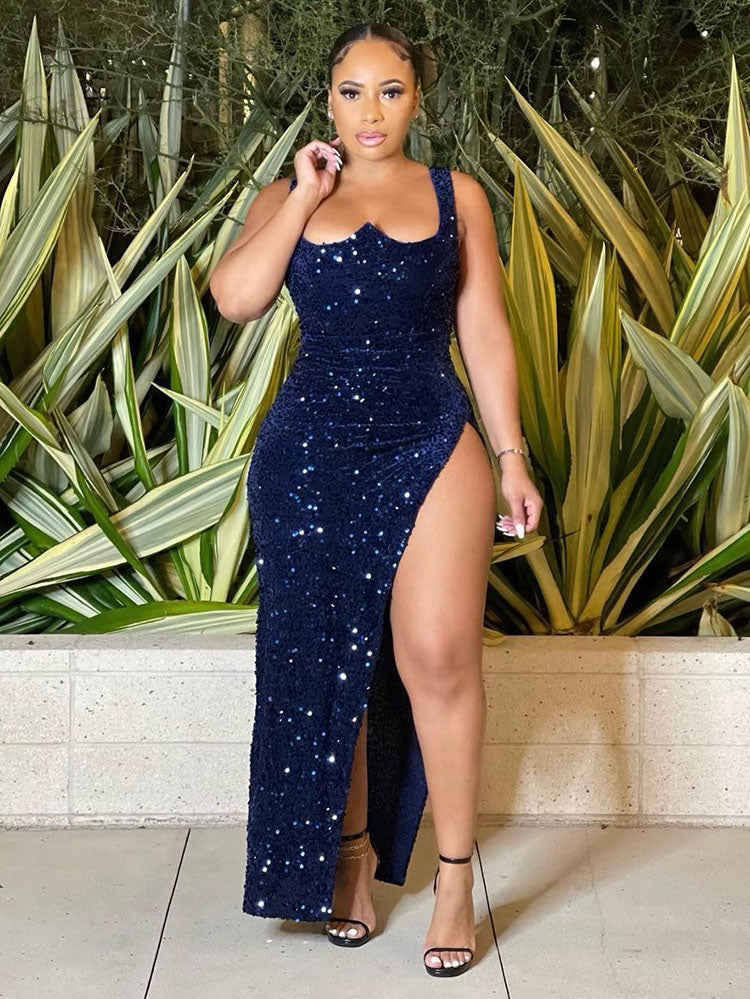 Woman wearing a navy blue sequined gown with a high slit