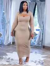 Woman wearing a long-sleeved tan midi dress with a keyhole neckline and sheer side panels.