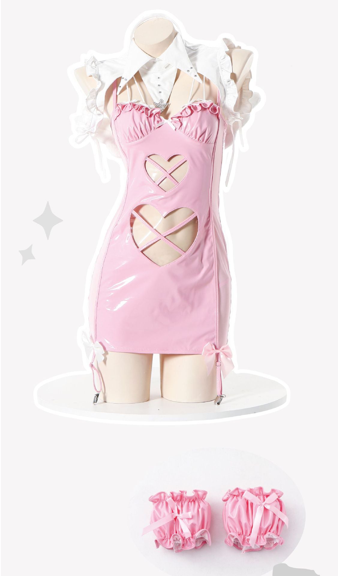 Pink patent mini dress with harness detail, cut-outs, bows, and ruffled collar.