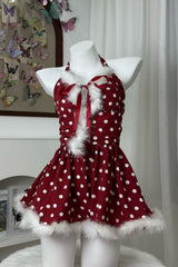 front view of a red and white polka dot halter dress with faux fur trim