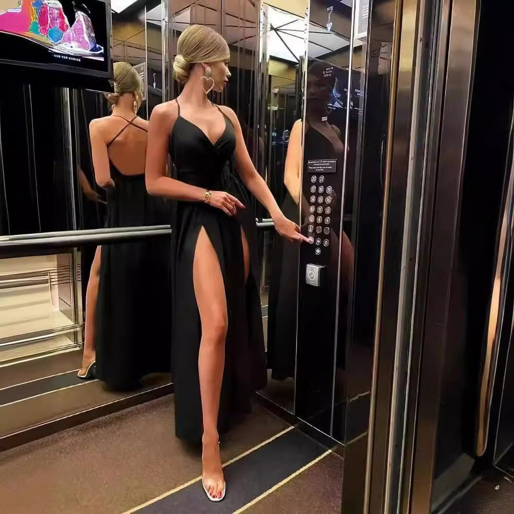 Woman in a black dress with high leg slits in an elevator