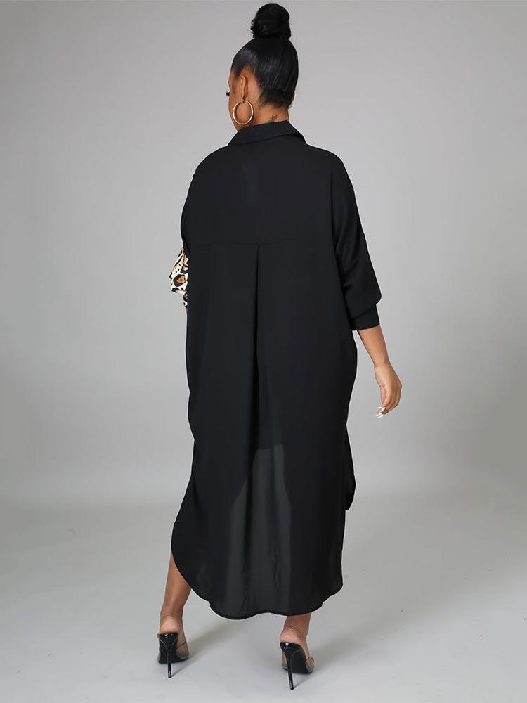 Back view of a woman in a black shirt dress with leopard print detail on the sleeve and an asymmetrical hem.