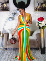 Woman in a sleeveless, gradient maxi dress with a deep V-neck and tie-front detail, holding a round woven handbag.