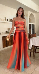 Woman wearing a strapless ombre maxi dress with cut-out details
