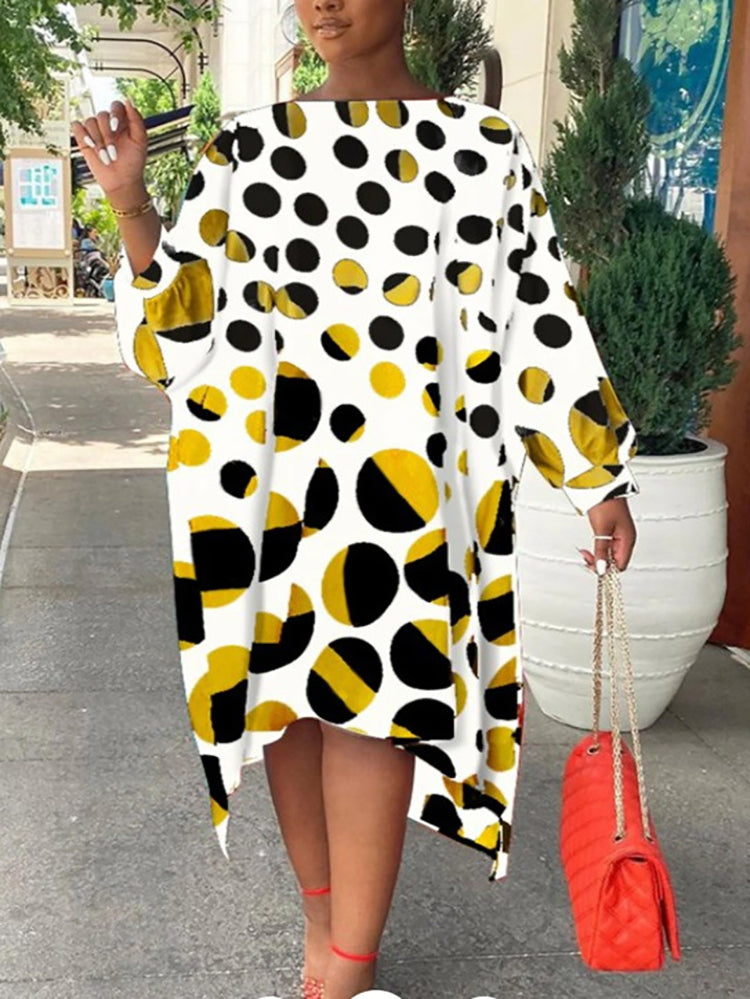 Woman in a white and yellow polka dot midi dress with a red handbag