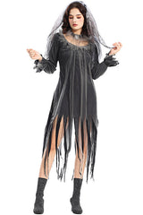 Woman wearing a dark, tattered, floor-length gown with a sheer overlay and veil, posing with one hand on her hip.